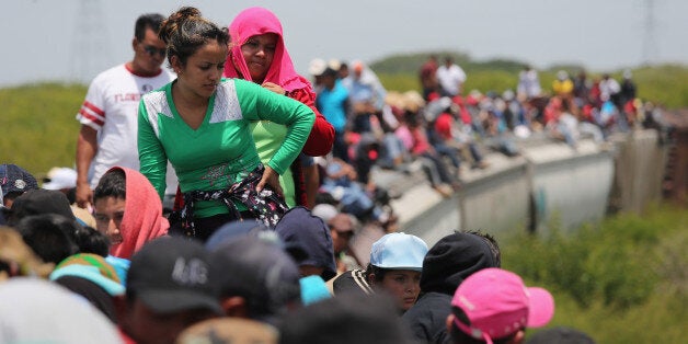 JUCHITAN, MEXICO - AUGUST 06: Central American immigrants ride north on top of a freight train on August 6, 2013 near Juchit