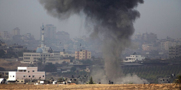 A picture taken from the southern Israeli border with the Gaza Strip shows smoke billowing following Israeli air strikes insi