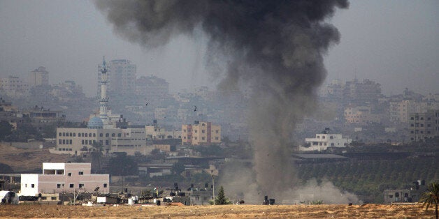 A picture taken from the southern Israeli border with the Gaza Strip shows smoke billowing following Israeli air strikes inside the Palestinian territory on November 17, 2012. Israeli air strikes hit the cabinet headquarters of Gaza's Hamas government after militants fired rockets at Jerusalem and Tel Aviv as Israel called up thousands more reservists in readiness for a potential ground war. AFP PHOTO /MENAHEM KAHANA (Photo credit should read MENAHEM KAHANA/AFP/Getty Images)