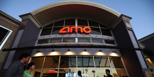 People walk past movie theaters of the US cinema chain AMC Entertainment in Monterey Park, east of downtown Los Angeles on Ma