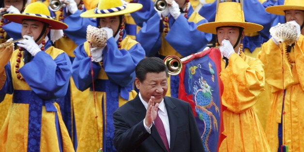 SEOUL, SOUTH KOREA - JULY 03: Chinese President Xi Jinping greets South Korean children during a welcoming ceremony held at the presidential Blue House on July 3, 2014 in Seoul, South Korea. President Xi Jinping is visiting Seoul before Pyongyang during his first trip to the Korean Peninsula as Chinese President. (Photo by Chung Sung-Jun/Getty Images)