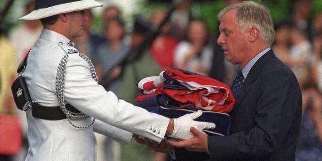 Hong Kong, HONG KONG: (FILES) Chris Patten (R), the 28th and last governor of colonial Hong Kong, receives the Union Jack fla