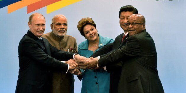 (L to R) Russian President Vladimir Putin, India's PM Narendra Modi, Brazilian President Dilma Rousseff, China's President Xi Jinping and South Africa's Jacob Zuma gesture during the 6th BRICS Summit in Fortaleza, Brazil, on July 15, 2014. Leaders of the BRICS (Brazil, Russia, India, China and South Africa) group of emerging powers gathered in Brazil on Tuesday to launch a new development bank and a reserve fund seen as counterweights to Western-led financial institutions. AFP PHOTO / NELSON ALMEIDA (Photo credit should read NELSON ALMEIDA/AFP/Getty Images)