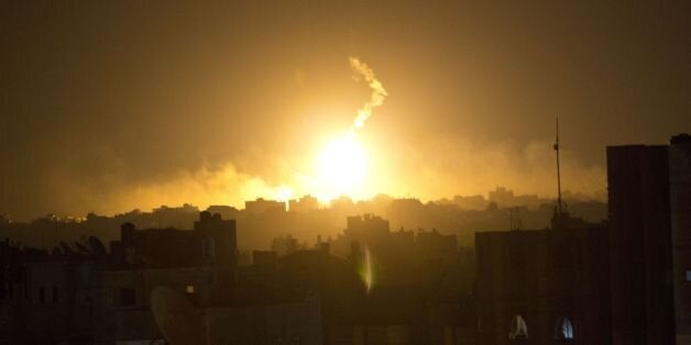 Fire explodes during an Israeli shelling in the eastern part of Gaza City on July 20,2014. Israel's operation against Hamas saw one of its bloodiest days with 46 Palestinians killed in Gaza and two Israeli soldiers dying in a clash with militants who infiltrated the Jewish state. As Israeli warplanes bombarded Gaza from the air, and ground troops pressed an assault on land, the Palestinian death toll rose to 342, with rights groups warning that a growing number of victims are children. AFP PHOTO / MAHMUD HAMS (Photo credit should read MAHMUD HAMS/AFP/Getty Images)