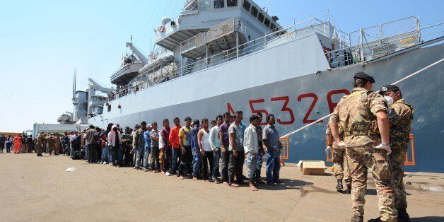 More than 2.000 Immigrants disembark from Italian military ship 'Etna' on July 19, 2014 in the port of Salerno, southern Italy, following Mare Nostrum rescue operations at sea. There has been a sharp rise in migrant landings in recent weeks because of the calm summer weather and growing lawlessness in Libya, with hundreds of migrants now being intercepted by Italian authorities every day. Most of them come from Eritrea, Somalia and Syria but there are also asylum-seekers arriving from Afghanistan, Pakistan and other parts of Asia as well as sub-Saharan Africa. AFP PHOTO / MARIO LAPORTA (Photo credit should read MARIO LAPORTA/AFP/Getty Images)