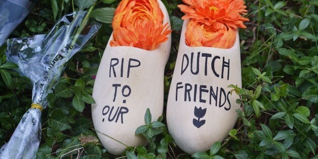 A pair of clogs with a message for Dutch citizens killed on the Malaysia Airlines flight MH17 is seen in front of the Netherl