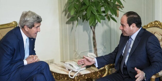 Egypts President Abdel Fattah al-Sisi (R) and US Secretary of State John Kerry talk before a meeting at the Presidential Pala