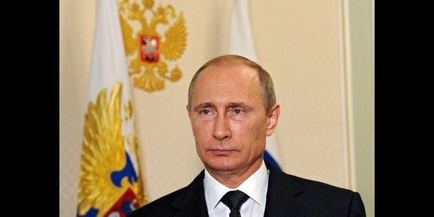 Russia's President Vladimir Putin looks on in the Novo-Ogaryovo residence outside Moscow, early on July 21, 2014, while recording his video address on the Malaysia Airlines crash. In his overnight video address shown today in the early hours Putin said that the Malaysia Airlines crash should not be used for 'political ends' and international experts given access to the crash site, without announcing specific steps by Moscow. AFP PHOTO / RIA-NOVOSTI / POOL/ MIKHAIL KLIMENTYEV (Photo credit should read MIKHAIL KLIMENTYEV/AFP/Getty Images)