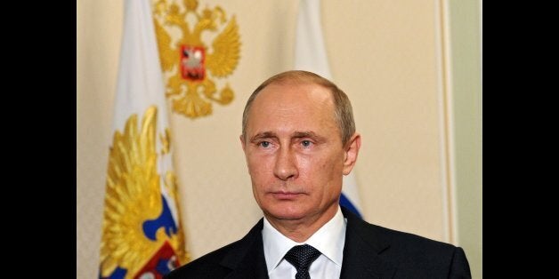 Russia's President Vladimir Putin looks on in the Novo-Ogaryovo residence outside Moscow, early on July 21, 2014, while recording his video address on the Malaysia Airlines crash. In his overnight video address shown today in the early hours Putin said that the Malaysia Airlines crash should not be used for 'political ends' and international experts given access to the crash site, without announcing specific steps by Moscow. AFP PHOTO / RIA-NOVOSTI / POOL/ MIKHAIL KLIMENTYEV (Photo credit should read MIKHAIL KLIMENTYEV/AFP/Getty Images)