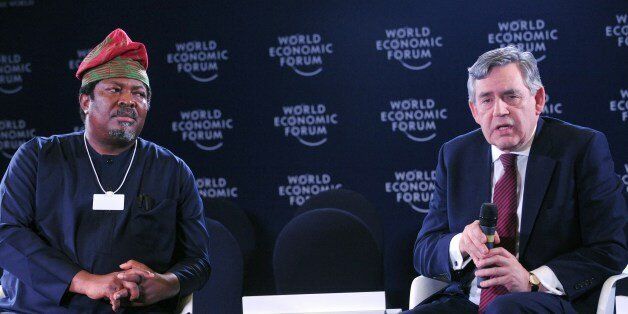 Former British Prime Minister Gordon Brown (R) speaks next to Publisher of This Day newspapers Nduka Obaigbena about 'Safe Schools Initiative' at the World Economic Forum in Abuja on May 7, 2014. The World Economic Forum on Africa kicked off in Abuja today in the shadow of security fears and mounting global concern about the plight of more than 200 schoolgirls abducted by Islamist militants. The showcase regional conference, dubbed 'Africa's Davos', had been meant to turn the spotlight on the host nation, which recently became the continent's largest economy, promote it as a place to do business and reflect its growing global clout. Instead, the build-up has been dominated by the 223 girls still missing after being abducted in the remote northeastern town of Chibok three weeks ago by Boko Haram fighters, who have since threatened to sell them as slave brides.AFP PHOTO/PIUS UTOMI EKPEI (Photo credit should read PIUS UTOMI EKPEI/AFP/Getty Images)