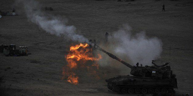 An Israeli tank fires a 155mm shell towards targets in the Gaza Strip from their position near Israel's border with the Palestinian enclave on July 23, 2014. The UN Human Rights Council on Wednesday launched a probe into the Gaza offensive, backing calls by the Palestinians to hold Israel to account despite fierce opposition from the Jewish state. The decision came after a marathon seven-hour emergency session of the top UN human rights body, where the Israelis and the Palestinians traded accusations over war crimes. AFP PHOTO / DAVID BUIMOVITCH (Photo credit should read DAVID BUIMOVITCH/AFP/Getty Images)