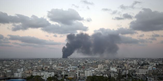 Smoke billows from a building hit by an Israeli air strike in Gaza City on July 25, 2014. Israel rejected a Gaza ceasefire proposal presented by US Secretary of State John Kerry, Israeli public television reported. AFP PHOTO/ MAHMUD HAMS (Photo credit should read MAHMUD HAMS/AFP/Getty Images)