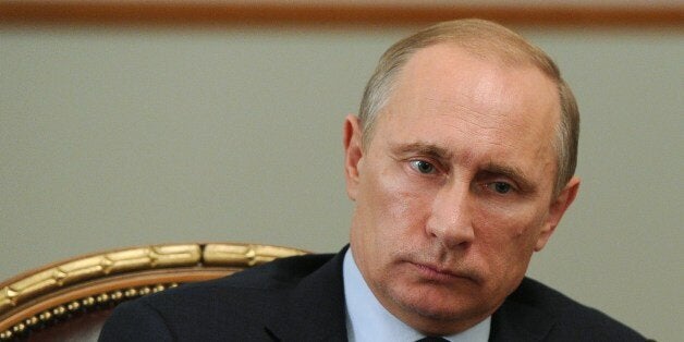 Russia's President Vladimir Putin attends a meeting in his Novo-Ogaryovo residence outside Moscow, on July 24, 2014. Putin is