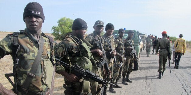 This photo taken on June 17, 2014 in Dabanga, northern Cameroon, shows Cameroon's army soldiers deploying as part of a reinforcement of its military forces against Nigerian Islamist group Boko Haram. Boko Haram, which in April 2014 kidnapped more than 200 schoolgirls in northeast Nigeria to international condemnation, has been waging a brutal, five-year insurgency that has claimed thousands of lives. AFP PHOTO / REINNIER KAZE (Photo credit should read Reinnier KAZE/AFP/Getty Images)