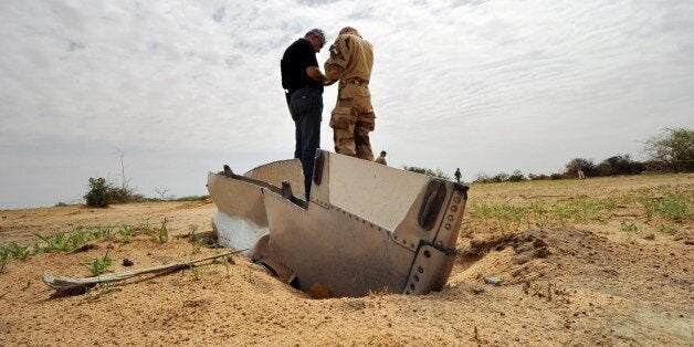 A French soldier talks with a representative of the Lebanese victims' relatives during a visit to the crash site of the Air A