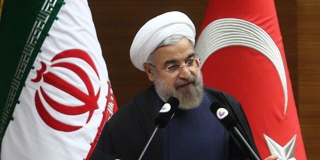 Iranian President Hassan Rouhani addresses a Turkish-Iranian business forum in Ankara on June 10, 2014. Rouhani said the sanctions hit country would try to secure a deal in negotiations with world powers on its long-running nuclear dispute. 'Iran will do its best for a final deal with the P5 plus 1,' made up of the five permanent UN Security Council members Britain, China, France, Russia and the United States, plus Germany, Rouhani told a business forum in Ankara through translated remarks. AFP PHOTO/ADEM ALTAN (Photo credit should read ADEM ALTAN/AFP/Getty Images)