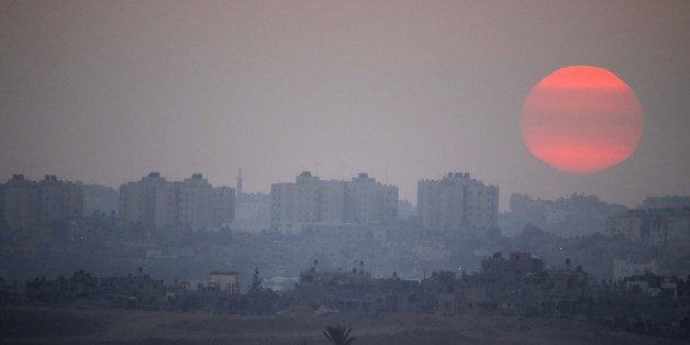 A picture taken from the Israeli border with the Gaza Strip shows the sun setting over the Palestinian coastl enclave on July 29, 2014.. The Israeli offensive, which began on July 8 to end Hamas rocket attacks on the Jewish state, has killed more than 1,100 Palestinians, mostly civilians according to the United Nations, while 56 lives have been lost on the Israeli side, all but three of them soldiers . AFP PHOTO / JACK GUEZ (Photo credit should read JACK GUEZ/AFP/Getty Images)