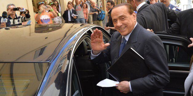 Italian former Prime Minister Silvio Berlusconi waves as he leaves after a press conference on June 18, 2014 in Rome. AFP PHOTO / ANDREAS SOLARO (Photo credit should read ANDREAS SOLARO/AFP/Getty Images)