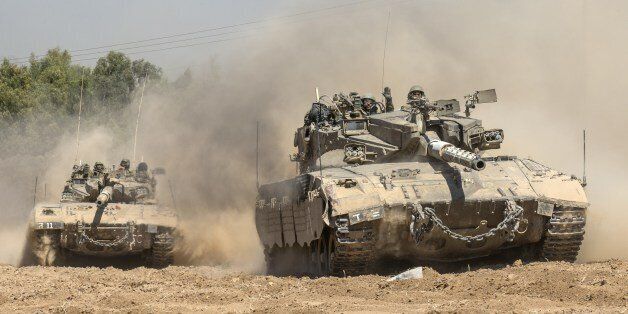 Israeli Merkava tanks roll to the southern Israeli border with the Gaza Strip, on August 1, 2014. Israeli forces in the southern Gaza Strip are searching for a missing soldier they fear may have been captured by militants at the start of a new ceasefire, the army said. AFP PHOTO / JACK GUEZ (Photo credit should read JACK GUEZ/AFP/Getty Images)