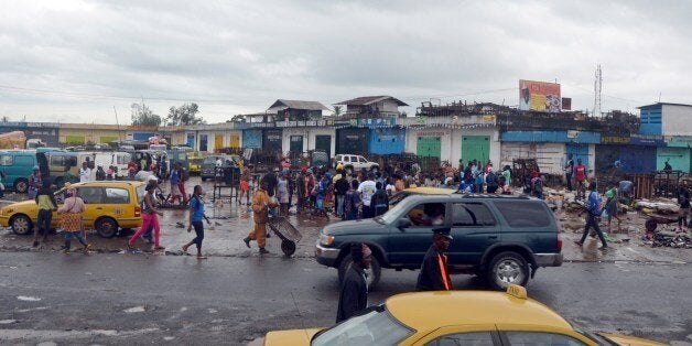 People walk at the closed Red Light market in Monrovia where offices and shops were closed as part of a disinfection campaign against the epidemic of the haemorrhagic fever Ebola on August 1, 2014. The head of the World Health Organization and presidents of the west African countries suffering the world's worst-ever Ebola outbreak meet in Guinea today to launch a $100 million (75 million euros) emergency joint response plan. AFP PHOTO / ZOOM DOSSO (Photo credit should read ZOOM DOSSO/AFP/Getty Images)