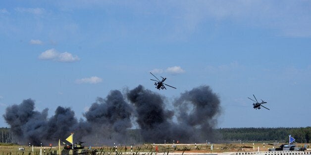 Russia's helicopters perform before the start of a tank biathlon, a paramilitary international competition with armour races