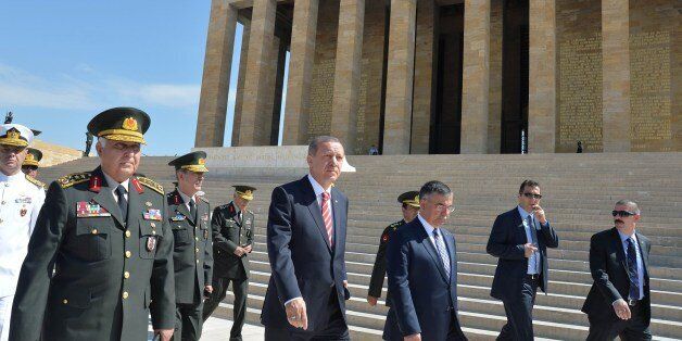 Turkish Prime Minister Recep Tayyip Erdogan (C), Turkish military Chief of Staff General Necdet Ozel (2nd L) and Turkish National Defense Minister Ismet Yilmaz (3rd R) visit the mausoleum of Turkey's founder Mustafa Kemal Ataturk prior to a meeting of the High Military Council in Ankara, on August 4, 2014. Turkish voters will directly elect their head of state for the first time in the country's modern history in Sunday's election, with Prime Minister Recep Tayyip Erdogan the hot favourite to become president. AFP PHOTO / STRINGER (Photo credit should read STRINGER/AFP/Getty Images)