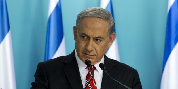 Israeli Prime Minister Benjamin Netanyahu gives a press conference at his Jerusalem offices, on August 6, 2014. Netanyahu launched a vigorous defence of Israel's month-long conflict in Gaza as 'justified' and 'proportionate', blaming Hamas for the heavy Palestinian civilian death toll. Israel lost 67 people during the fighting -- 64 soldiers and three civilians, one of them a Thai worker. Palestinian medics said 1,875 Gazans died, including 430 children and 243 women. AFP PHOTO/JIM HOLLANDER/POOL (Photo credit should read JIM HOLLANDER/AFP/Getty Images)