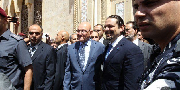Former Lebanese premier Saad Hariri (C-R) poses for a picture with current Prime Minister Tammam Salam (C-L) after their meeting at the governmental palace in Beirut on August 8, 2014 upon Hariri's return to Lebanon after three years in self-imposed exile. The surprise return home by Hariri, the country's most prominent Sunni leader, comes after he announced that Saudi King Abdullah had promised him Riyadh would provide Lebanon with $1 billion to fight jihadists on the Syrian border. AFP PHOTO / ANWAR AMRO (Photo credit should read ANWAR AMRO/AFP/Getty Images)