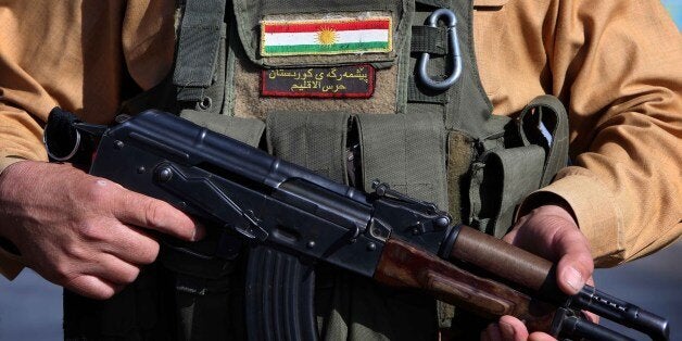 Iraqi Kurdish Peshmerga fighters take position on the front line in Khazer, near the Kurdish checkpoint of Aski kalak, 40 km West of Arbil, the capital of the autonomous Kurdish region of northern Iraq, on August 8, 2014. A spokesman for the Kurdish peshmerga force said US warplanes bombed Islamic State jihadist targets in two areas of northern Iraq. AFP PHOTO/SAFIN HAMED (Photo credit should read SAFIN HAMED/AFP/Getty Images)