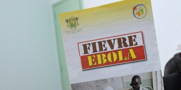 Coulibaly Daouda, head of the epidemiological department at the national public health institute in Abidjan poses as he holds a poster reading ''Ebola fever'', on August 8, 2014. The World Health Organization declared the killer Ebola epidemic ravaging parts of west Africa an international health emergency and appealed for global aid to help afflicted countries. States of emergency have been declared in the hardest hit countries of Guinea, Liberia and Sierra Leone, while two people have died in Nigeria and Benin is investigating a suspect patient. AFP PHOTO/ SIA KAMBOU (Photo credit should read ISSOUF SANOGO/AFP/Getty Images)