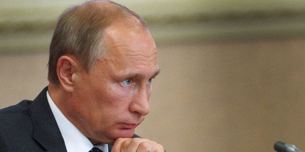 Russian President Vladimir Putin attends a local administration meeting as he visits Voronezh on August 5, 2014. Putin will t