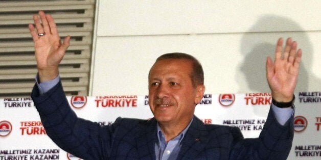 Newly elected Turkish president Recep Tayyip Erdogan waves at supporters from the balcony of the AKP party headquarters during the celebrations of his victory in the presidential election vote in Ankara on August 10, 2014. Prime Minister Recep Tayyip Erdogan on Sunday won Turkey's presidency in the first round of elections with 52.1 percent of the vote, an almost complete vote count said. Erdogan's main rival Ekmeleddin Ihsanoglu won 38.8 percent of the vote and Kurdish candidate Selahattin Demirtas 9.1 percent of the vote, Turkish television channels said, based on a 99 percent vote count.AFP PHOTO/ADEM ALTAN (Photo credit should read ADEM ALTAN/AFP/Getty Images)