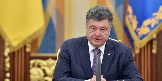 Ukrainian President Petro Poroshenko speaks during a National Security and Defence Council sitting in Kiev on June 16, 2014. Poroshenko said during the opening of the sitting that a ceasefire was the beginning of his peace plan for resolving the conflict in eastern Ukraine. AFP PHOTO/ SERGEI SUPINSKY (Photo credit should read SERGEI SUPINSKY/AFP/Getty Images)