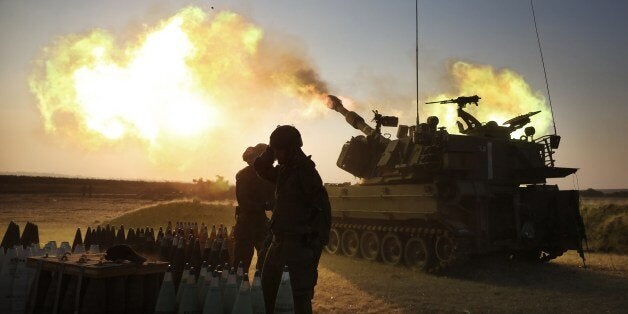 Israeli soldiers of the 155mm artillery cannons unit fire towards the Gaza Strip from their position near Israel's border with the coastal Palestinian enclave, on July 21, 2014. World efforts to broker a ceasefire in war-torn Gaza gathered pace as Israel pressed a blistering 14-day assault on the enclave, pushing the Palestinian death toll to 558. AFP PHOTO/MENAHEM KAHANA (Photo credit should read MENAHEM KAHANA/AFP/Getty Images)