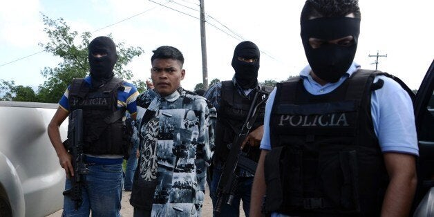 Agents of the Bureau of Criminal Investigation and the Special Response Squad arrest Mara 18's leader Joaquin Garcia, aka 'El