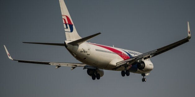 A Malaysia Airlines plane prepares for landing at the Kuala Lumpur International Airport in Sepang, outside Kuala Lumpur on July 21, 2014. Malaysia Airlines said it would offer full refunds to customers who want to cancel their tickets in the wake of the MH17 disaster, just months after the carrier suffered another blow when flight MH370 dissapeared. AFP PHOTO/ MOHD RASFAN (Photo credit should read MOHD RASFAN/AFP/Getty Images)