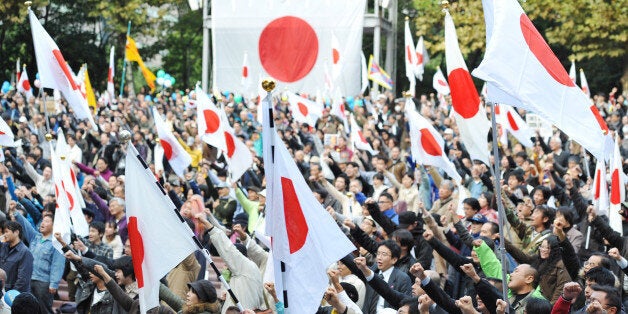 Protesters chant slogans during an anti-China protest rally in central Tokyo on November 6, 2010. Japanese national flags fluttered as more than 3,500 people gathered for a thrid major rally since a bitter territorial row flared up on a maritime incident last month near the disputed islands known as Senkaku by Japan and claimed under the name Diaoyu by China. AFP PHOTO / Tadayuki YOSHIKAWA (Photo credit should read Tadayuki YOSHIKAWA/AFP/Getty Images)