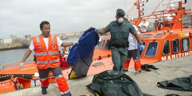 Members of the Guardia Civil and Red Cross unload dinghy boats used by would-be immigrants to cross the Strait of Gibraltar, at Tarifa's harbour on August 11, 2014. Spain's coastguard today rescued more than 260 sub-Saharan African migrants crossing the Strait of Gibraltar on small boats. Many migrants from sub-Saharan Africa attempt to cross into Spain from Morocco, either by sea through the Strait of Gibraltar or overland, via the Spanish enclaves of Ceuta and Melilla in the extreme north of Morocco. AFP PHOTO / MARCOS MORENO (Photo credit should read MARCOS MORENO/AFP/Getty Images)