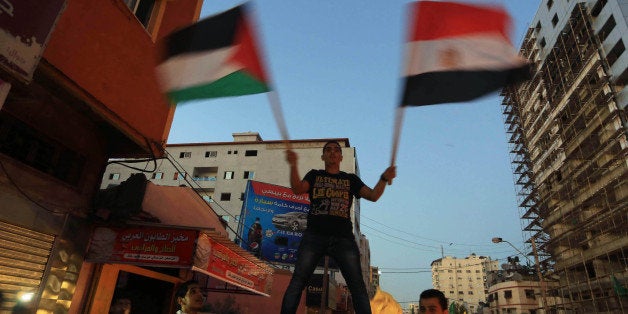 GAZA CITY, GAZA - AUGUST 26 : Palestinians celebrate the ceasefire between Palestinian resistance factions and Israel in Gaza City, Gaza on August 26, 2014. An Egyptian-brokered ceasefire went into effect on August 26, 2014, bringing to a halt 51 days of attacks. (Photo by Mohammad Asad/Anadolu Agency/Getty Images)