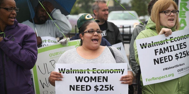 CHICAGO, IL - JUNE 04: Wal-Mart workers and union activists protest outside a Wal-Mart store on June 4, 2014 in Chicago, Illinois. Workers and activists were scheduled to hold strikes at Wal-Mart stores in more than 20 cities today in their campaign to raise wages. The strikes are scheduled to draw attention to worker grievances before Wal-Marts annual shareholder meeting which takes place June 6 in Fayetteville, Arkansas. (Photo by Scott Olson/Getty Images)