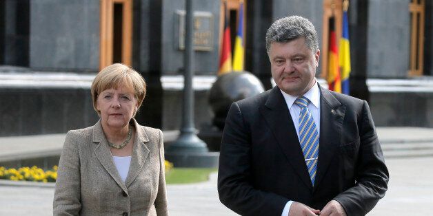 German chancellor Angela Merkel, left, and Ukrainian President Petro Poroshenko during their statement to the press in Kiev, Ukraine, Saturday, Aug. 23, 2014. German Chancellor Angela Merkel, who has advocated a measured European Union response to Russiaâs aggressive policies in Ukraine, met Ukrainian President Petro Poroshenko and said she urged a political solution to the crisis. Poroshenko, for his part, said Ukraine was willing to try to solve the conflict by talks, but not at the expense of the countryâs territorial integrity or sovereignty. (AP Photo/Efrem Lukatsky)