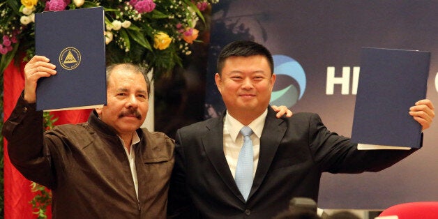 Nicaraguan President Daniel Ortega (L) stands with Wang Jing, president of of the Chinese company HK Nicaragua Development Gran Canal Interoceanico, during the framework agreement for the construction of the Interoceanic Grand Canal in Managua, on June 14, 2013. Nicaraguan lawmakers approved a controversial deal that would allow a Hong Kong company to build a $40 billion oceanic waterway to rival the Panama Canal, and then manage it for the next 50 years. Environmental activists fear the worst for Lake Nicaragua, which the planned waterway will pass through. AFP/Inti OCON (Photo credit should read Inti Ocon/AFP/Getty Images)