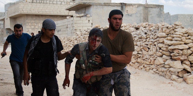 LEPPO, SYRIA - MAY 26: Two Free Syrian Army (FSA) members injured after a machine gun exploded while shooting outside the Ale