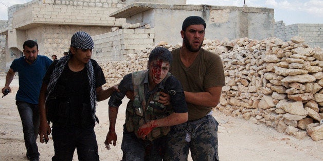 LEPPO, SYRIA - MAY 26: Two Free Syrian Army (FSA) members injured after a machine gun exploded while shooting outside the Aleppo prison on May 26, 2014. (Photo by Salih Mahmud Leyla/Anadolu Agency/Getty Images)