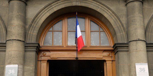 A picture taken on August 6, 2014 shows the entrance of Paris criminal investigation department headquarters, located at the 36 Quai des Orfevres in the French capital. A police source said on August 6 that the two French narcotics police officers who were placed in custody after being suspected of taking part in the stealing of over 50 kilos of seized cocaine from the Paris police headquarters, will be brought in front of a judge. On August 2, 2014, a first French narcotics police officer, 33-year-old, was arrested after it was believed he had made off with the illegal drugs -- which have a street value of up to two million euros ($2.7 million) -- after security cameras spotted a person resembling him entering the headquarters with two bags, according to a statement from police and prosecutors. On August 4, a second French narcotics police officer was arrested after his name was seen on the first police officer's bank statements. AFP PHOTO / BERTRAND GUAY (Photo credit should read BERTRAND GUAY/AFP/Getty Images)