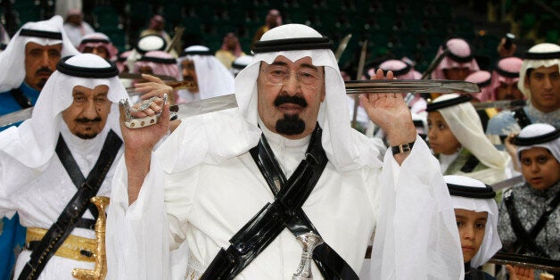 King Abdullah of Saudi Arabia, center, holds his sword as he takes part in the traditional Arda dance, or War dance, during the Janadriyah Festival of Heritage and Culture on the outskirts of Riyadh, Saudi Arabia, Tuesday, March 10, 2009. (AP Photo/Hassan Ammar)