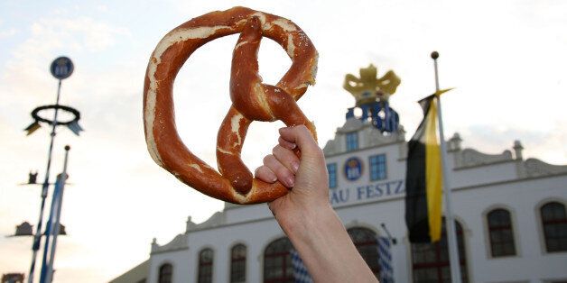 MUNICH, GERMANY - SEPTEMBER 21: A woman waves a pretzel in the air during day 2 of the Oktoberfest beer festival on September 21, 2008 in Munich, Germany. The Oktoberfest is seen as the biggest beer festival worldwide. (Photo by Chad Buchanan/Getty Images)