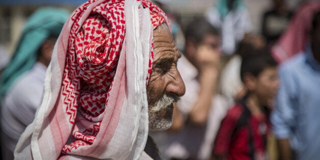 ZAKHO, KRG, IRAQ - 2014/08/24: French NGO Action Contre la Faim (A.C.F.) organizes a one month worth of ration, food distribution for Yazidi refugees in cooperation with World Food Program (U.N.) at Delal Refugee Campin Zakho. The Delal refugee camp sits within walking distance from the city center and It accommodates more than 1,000 Yazidi refugee families that have fled Sinjar starting August. It is roughly estimated that there are 100,000 Yazidi refugees seeking shelter in schools, under construction buildings and camps located around the city. (Photo by Vianney Le Caer/Pacific Press/LightRocket via Getty Images)