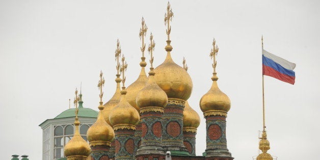 A picture taken on November 14, 2011, shows a Russian flag flying near the domes and crosses of Church of the Nativity in the Moscow Kremlin. AFP PHOTO / KIRILL KUDRYAVTSEV (Photo credit should read KIRILL KUDRYAVTSEV/AFP/Getty Images)