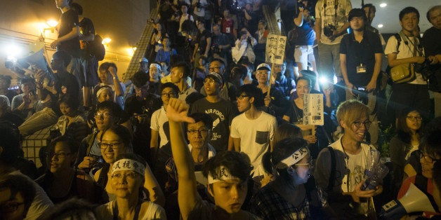 Pro-democracy activists gather outside the Grand Hyatt Hotel following a rally organized by activist group Occupy Central With Love and Peace (OCLP) in Hong Kong, China, on Monday, Sept. 1, 2014. The risk of Hong Kong's financial district being paralyzed by a mass sit-in is diminishing after a pro-democracy leader said the strategy of threatening civil disobedience had failed to persuade China to make concessions on changes to the city's leadership election. Photographer: Brent Lewin/Bloomberg via Getty Images